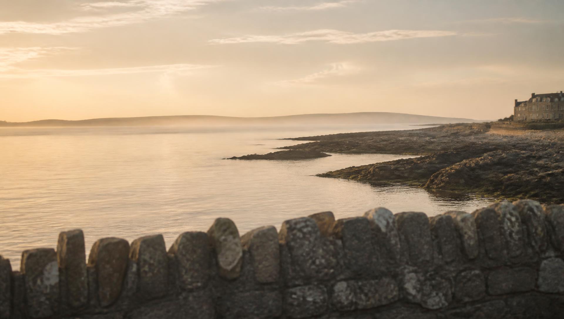 The Galway coastline at first light, looking out over calm Atlantic water